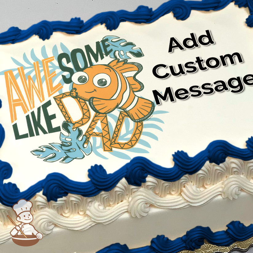 Cartoon clownfish with "AWESOME LIKE DAD" text, surounded by blue leaves, printed on a sheet cake.