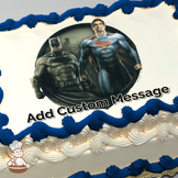 Batman and Superman standing side by side with a cityscape background, printed on a sheet cake.