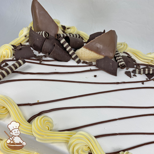 Sheet cake with chocolate dipped shortbread cookies and chocolate curls.