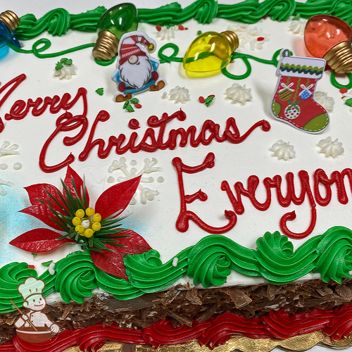 Sheet cake with snowflakes, sprinkles, holiday lights and poinsettias; and Christmas Gnome and stocking ring toys.