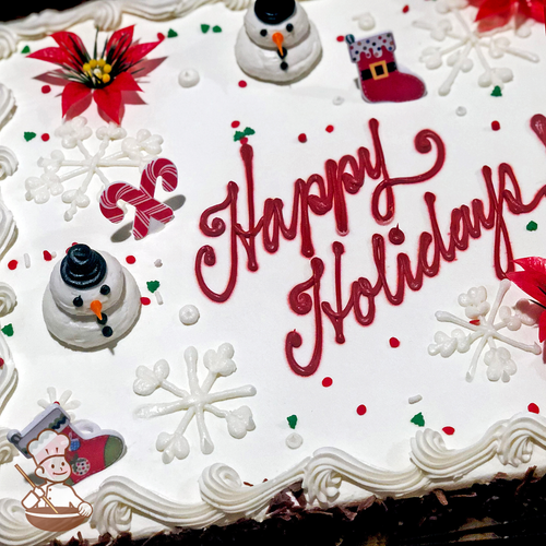 Holiday sheet cake with buttercream snowman and snowflakes with Christmas stocking ring toys.
