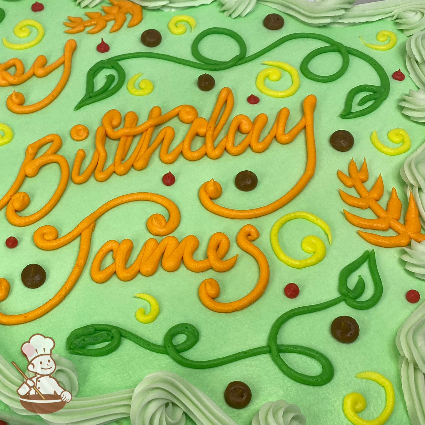 Sheet cake with Disney Encanto colors of buttercream piped ferns and vines with arrow tips.