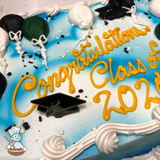 Graduation sheet cake with buttercream balloons and sprinkles against spray sky background and grad hat toy rings.