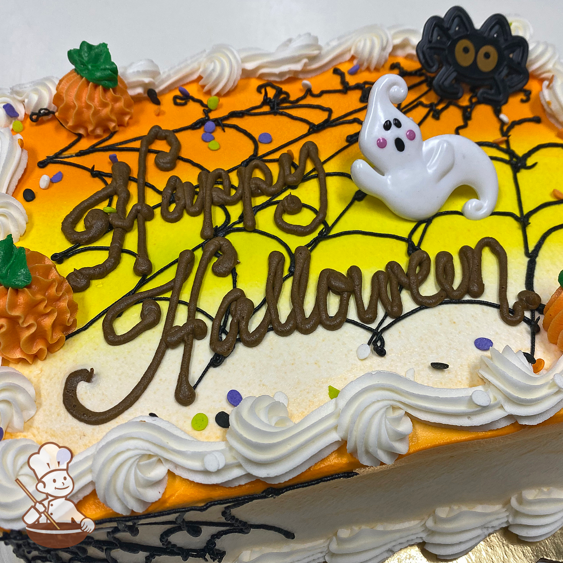 Halloween sheet cake with spider web and pumpkins on orange, yellow and white candy corn scene; with ghost and spider toys.