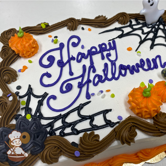 Halloween sheet cake with buttercream pumpkins, spider webs and sprinkles with ghost and spider toy rings.
