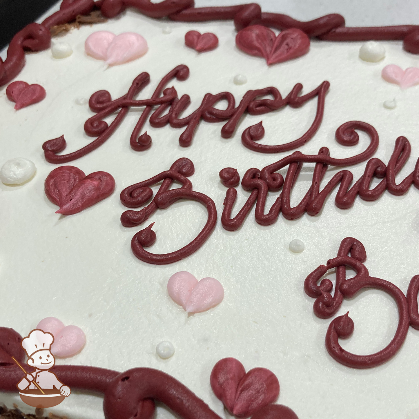 Valentine's Day sheet cake with buttercream hearts and dots.