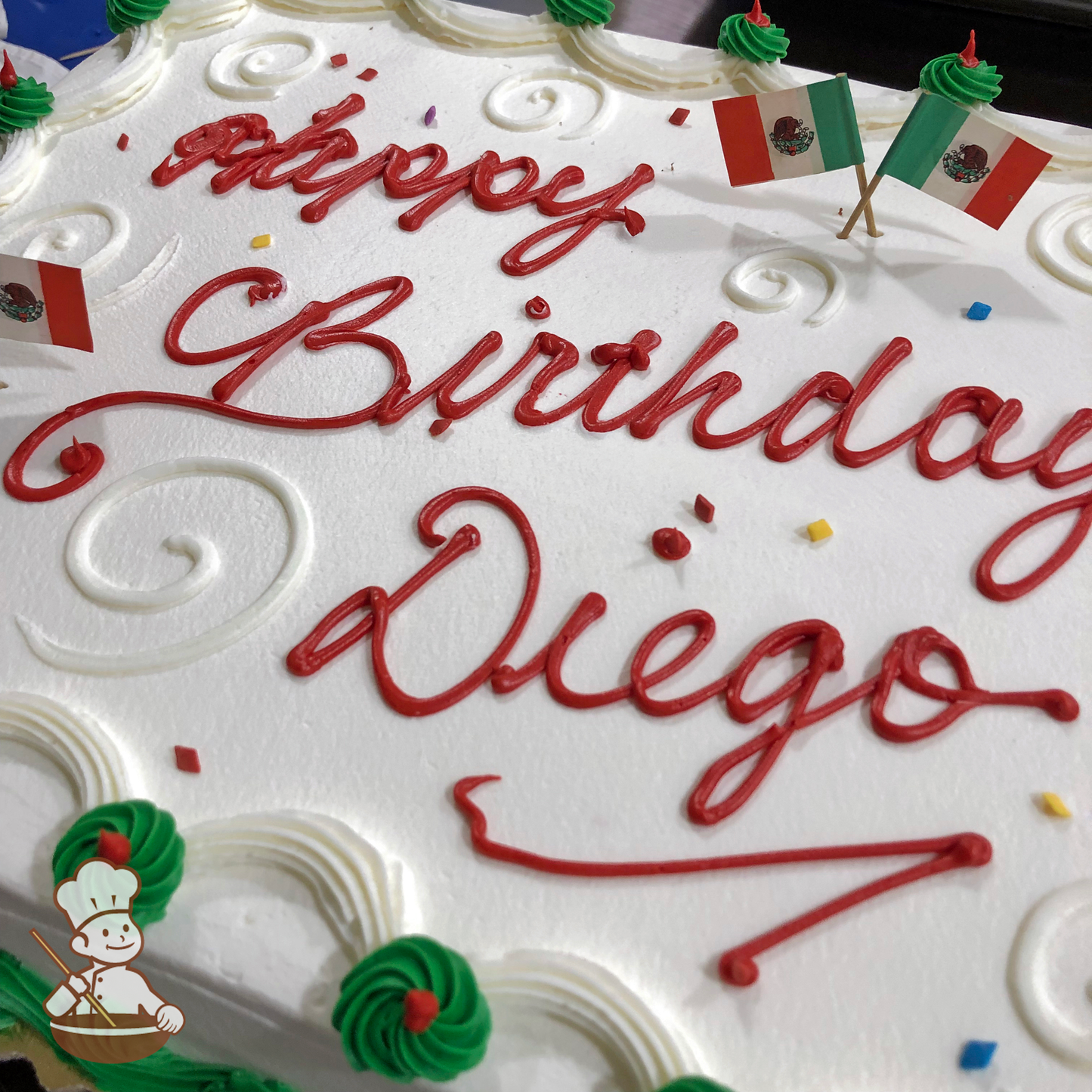 Birthday sheet cake with buttercream swirls and Mexico flag toothpicks.