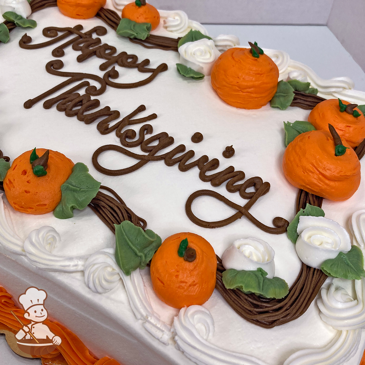 Thanksgiving sheet cake with buttercream pumpkins in a branch frame.