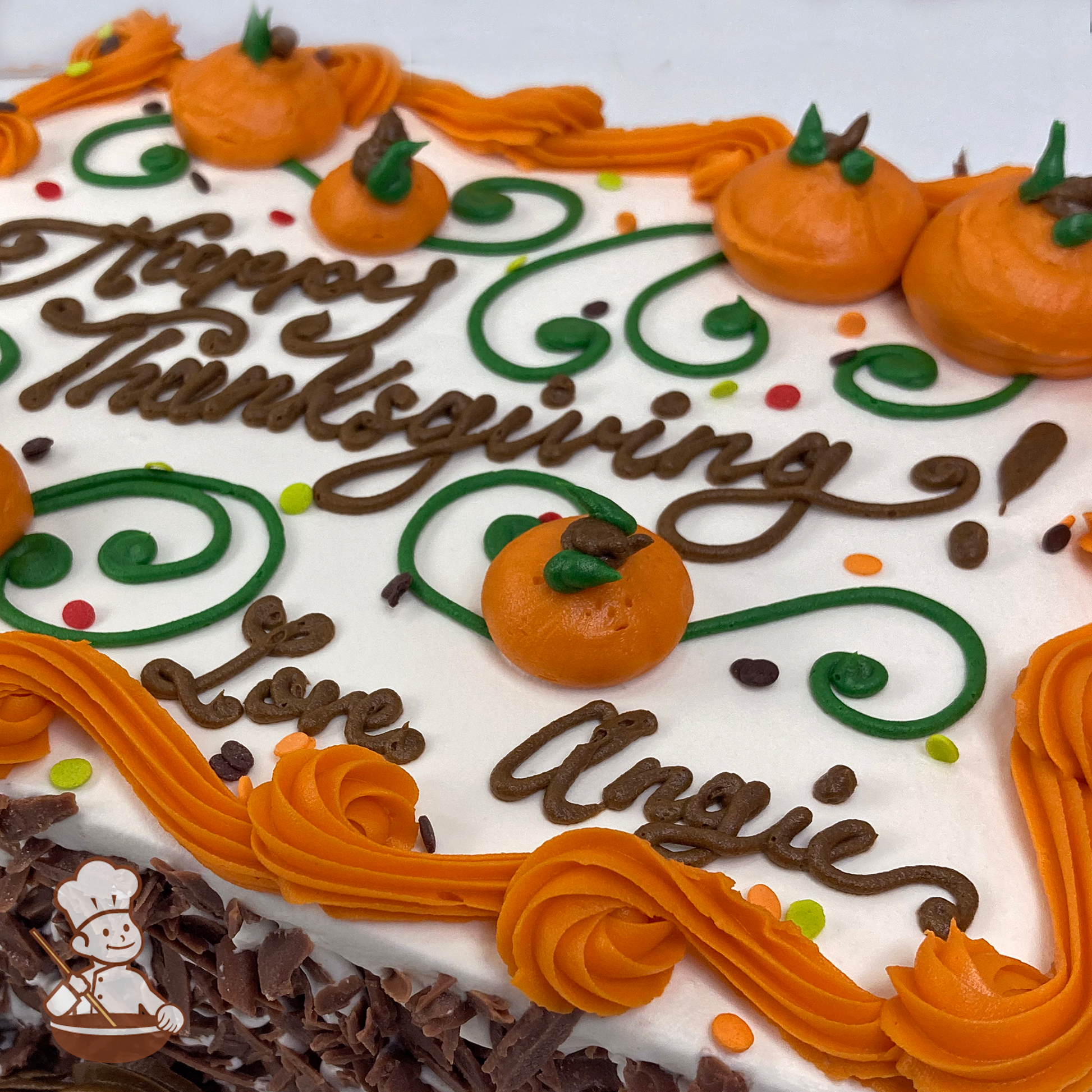 Thanksgiving sheet cake with buttercream pumpkins and scrolls and sprinkles.