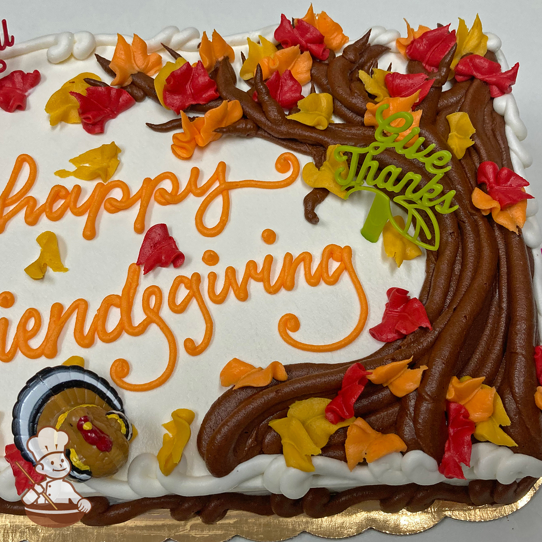 Thanksgiving sheet cake with buttercream tree and leaves with turkey toy.