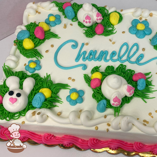 Spring sheet cake with buttercream bunny, grass, and flowers with sprinkles.