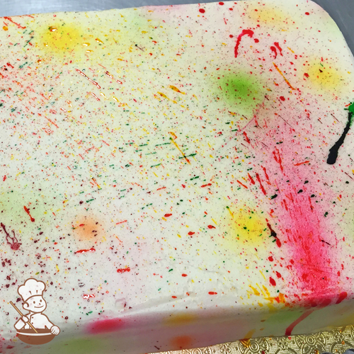 Celebration sheet cake with multi colors splattered on like paint.
