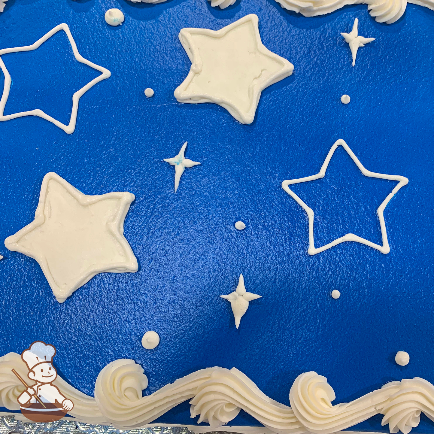 Celebration sheet cake with buttercream stars, diamond stars, dots, and outline of stars.
