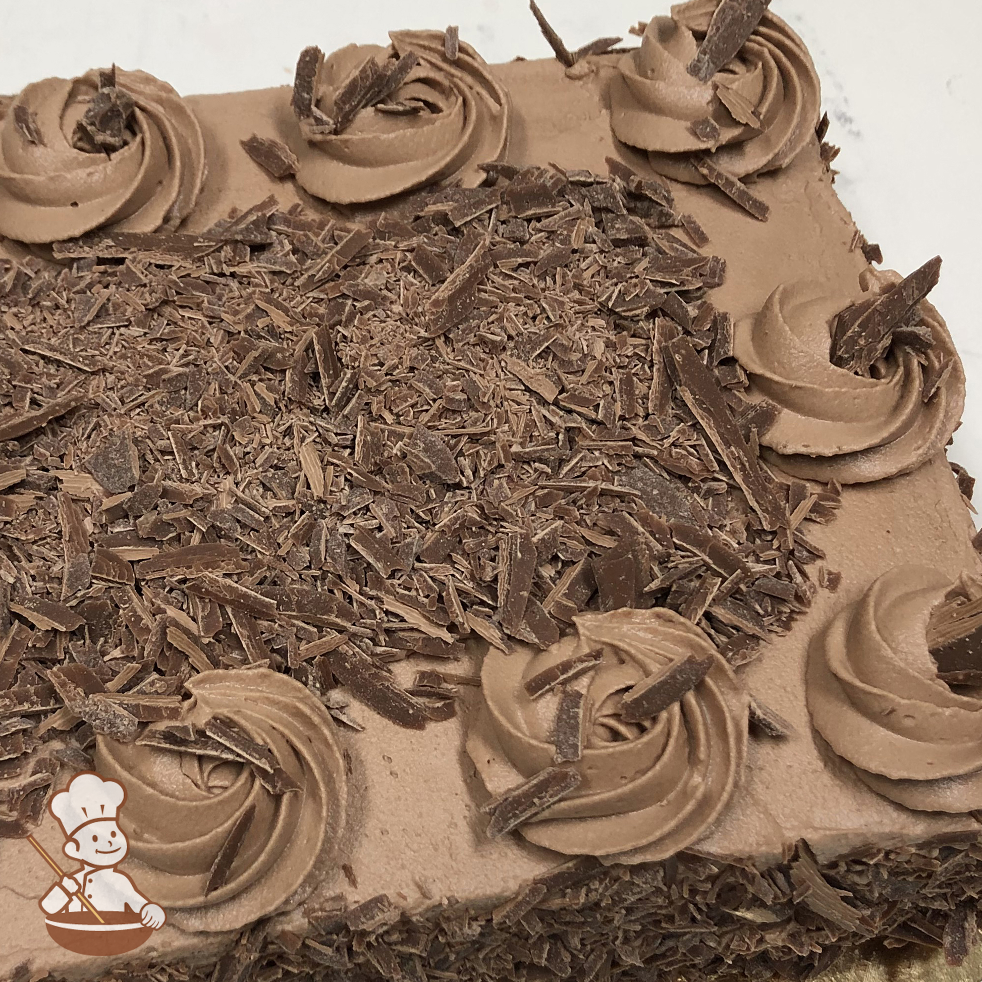 Celebration sheet cake with chocolate icing and chocolate shavings.