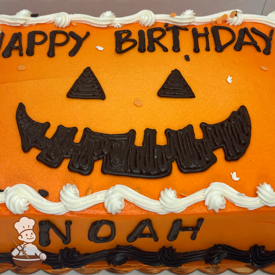 Birthday sheet cake of jack-o-lantern pumpkin piped on.