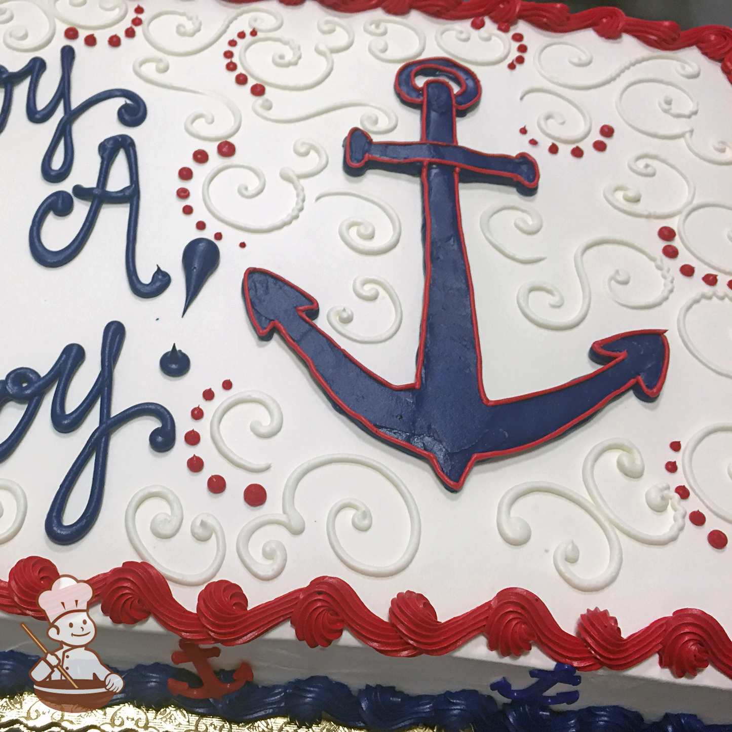 Baby shower sheet cake with boat anchor and scrolls.