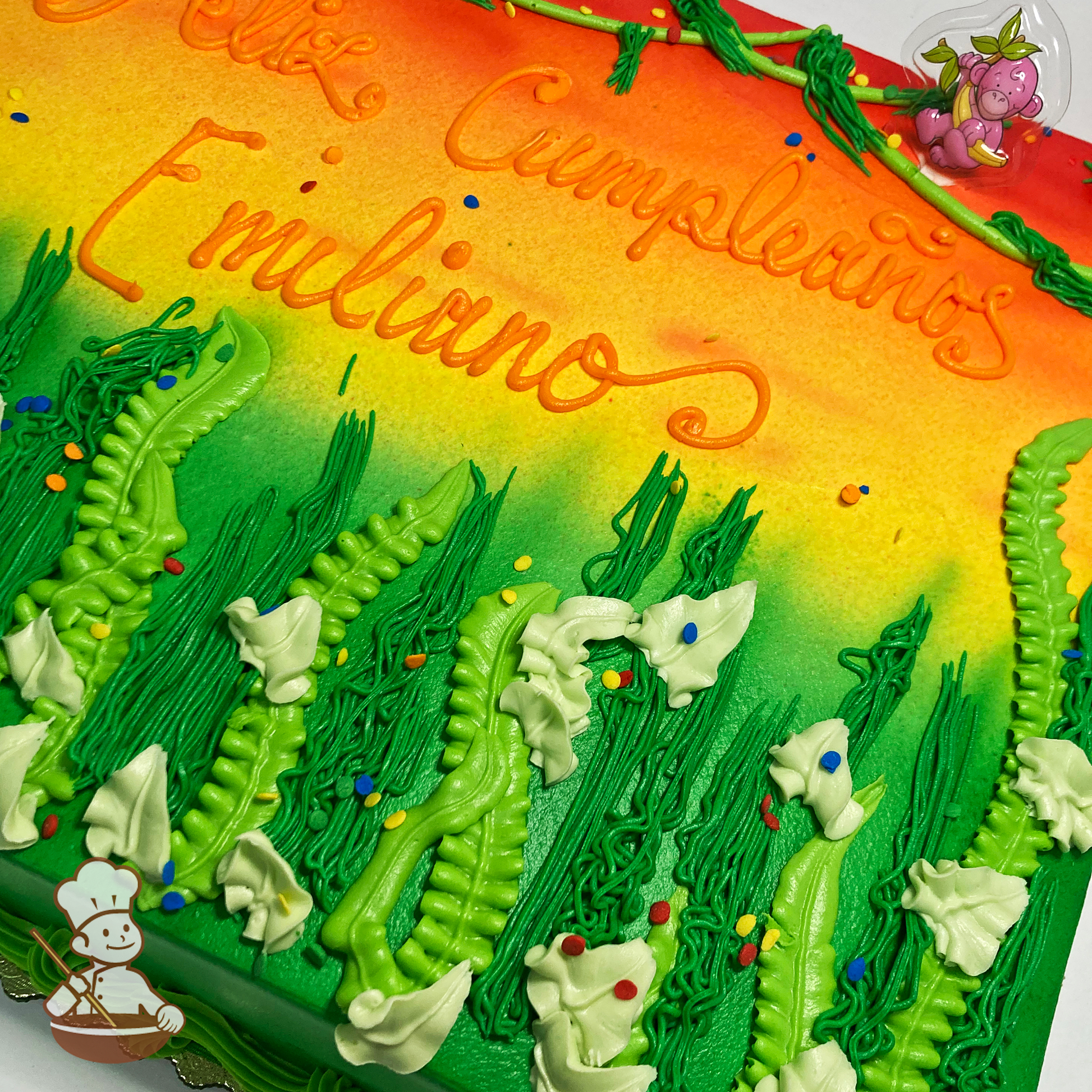 Birthday sheet cake with tall desert grass field and a sunset background sprayed on with jungle safari animal toy.