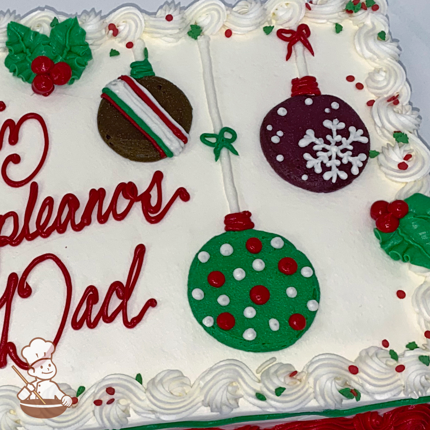 Birthday sheet cake with hanging buttercream piped Christmas ornaments and holly berries and sprinkles.