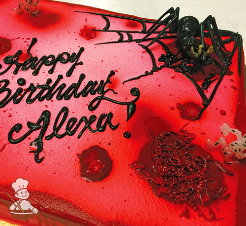 Birthday sheet cake with buttercream piped stomach and food coloring blood with spider web and toy.