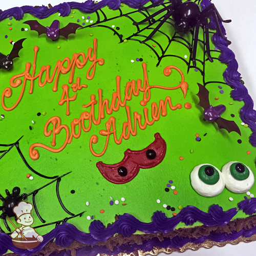 Birthday sheet cake with buttercream spooky eyeballs and spider web with toy spider and bats.