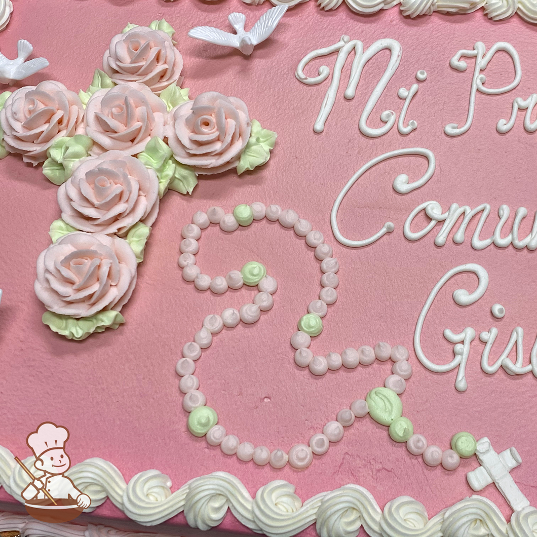 First communion sheet cake with buttercream roses in shapreof a cross and piped rosary and cross with toy doves.