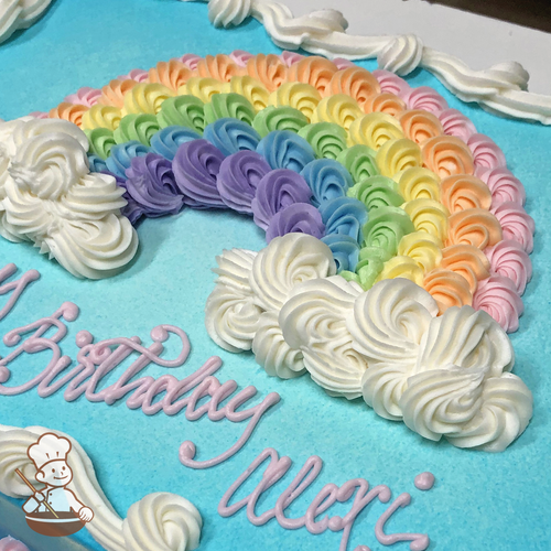 Birthday sheet cake with buttercream rainbow and clouds made of swirl patterns.