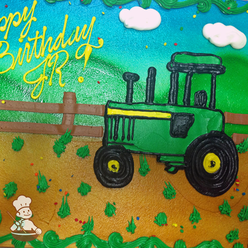 Birthday sheet cake with buttercream piped farm tractor on a field with fence and hills.