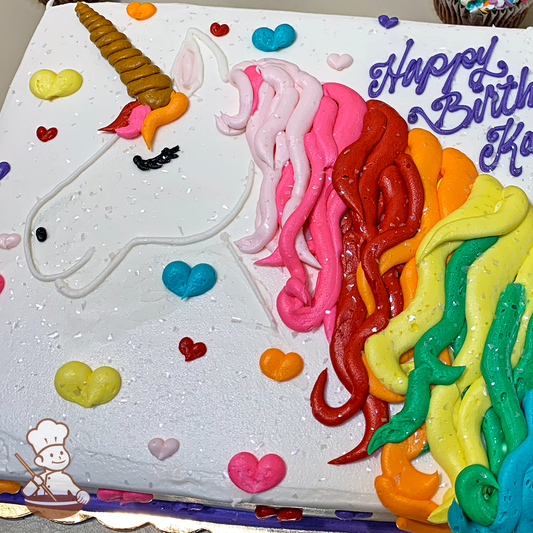 Birthday sheet cake with buttercream piped unicorn with colorful mane and horn and hearts.