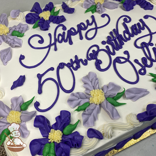 Happy Birthday sheet cake with purple and lavender Hawaiian flowers and petals.