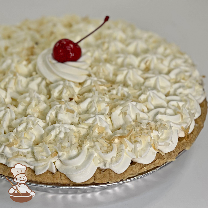 Coconut Cream Pie with whipped cream and toasted coconuts.