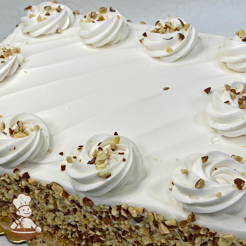 Sheet cake with whipped cream dollops and toasted almonds.