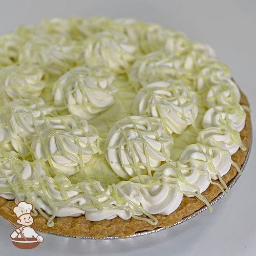 Key Lime Cream Pie with whipped cream and key lime curd drizzle.