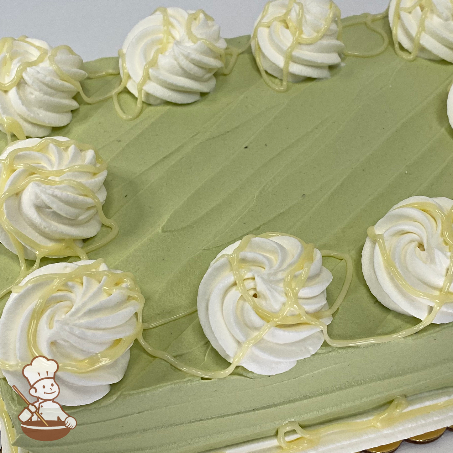 Sheet cake with match cream icing and white chocolate drizzle.