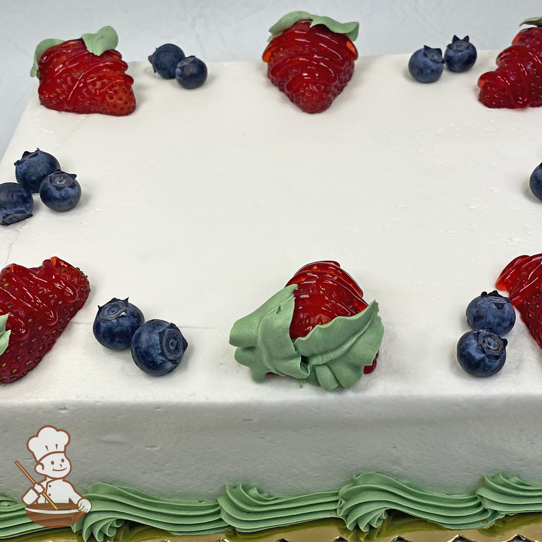 Sheet cake with fresh strawberries and blueberries.