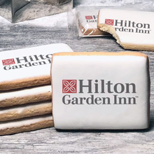 Load image into Gallery viewer, A stack of rectangle butter shortbread cookies with Hilton Garden Inn logo printed directly on a white, lemon sugar icing.