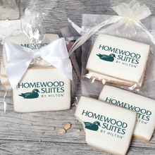 Load image into Gallery viewer, A stack of rectangular butter shortbread cookies with Homewood Suites by Hilton logo printed directly on a white, light sugar icing. Some cookies are shown in clear packaging with a twist-tie ribbon bow or inside an organza bag.