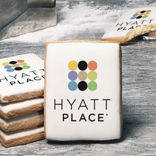 Load image into Gallery viewer, A stack of rectangle butter shortbread cookies with Hyatt Place logo printed directly on a white, lemon sugar icing.