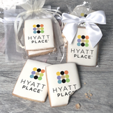 A stack of rectangular butter shortbread cookies with Hyatt Place logo printed directly on a white, light sugar icing. Some cookies are shown in clear packaging with a twist-tie ribbon bow or inside an organza bag.