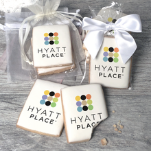 Load image into Gallery viewer, A stack of rectangular butter shortbread cookies with Hyatt Place logo printed directly on a white, light sugar icing. Some cookies are shown in clear packaging with a twist-tie ribbon bow or inside an organza bag.
