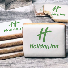Load image into Gallery viewer, A stack of rectangle butter shortbread cookies with Holiday Inn logo printed directly on a white, lemon sugar icing.