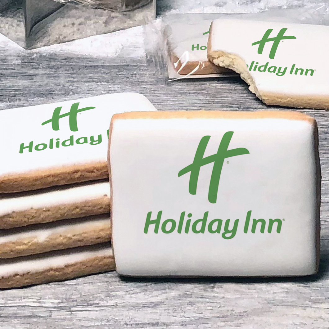 A stack of rectangle butter shortbread cookies with Holiday Inn logo printed directly on a white, lemon sugar icing.