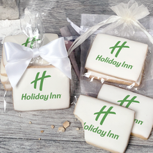 Load image into Gallery viewer, A stack of rectangular butter shortbread cookies with Holiday Inn logo printed directly on a white, light sugar icing. Some cookies are shown in clear packaging with a twist-tie ribbon bow or inside an organza bag.