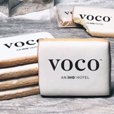 A stack of rectangle butter shortbread cookies with Voco logo printed directly on a white, lemon sugar icing.