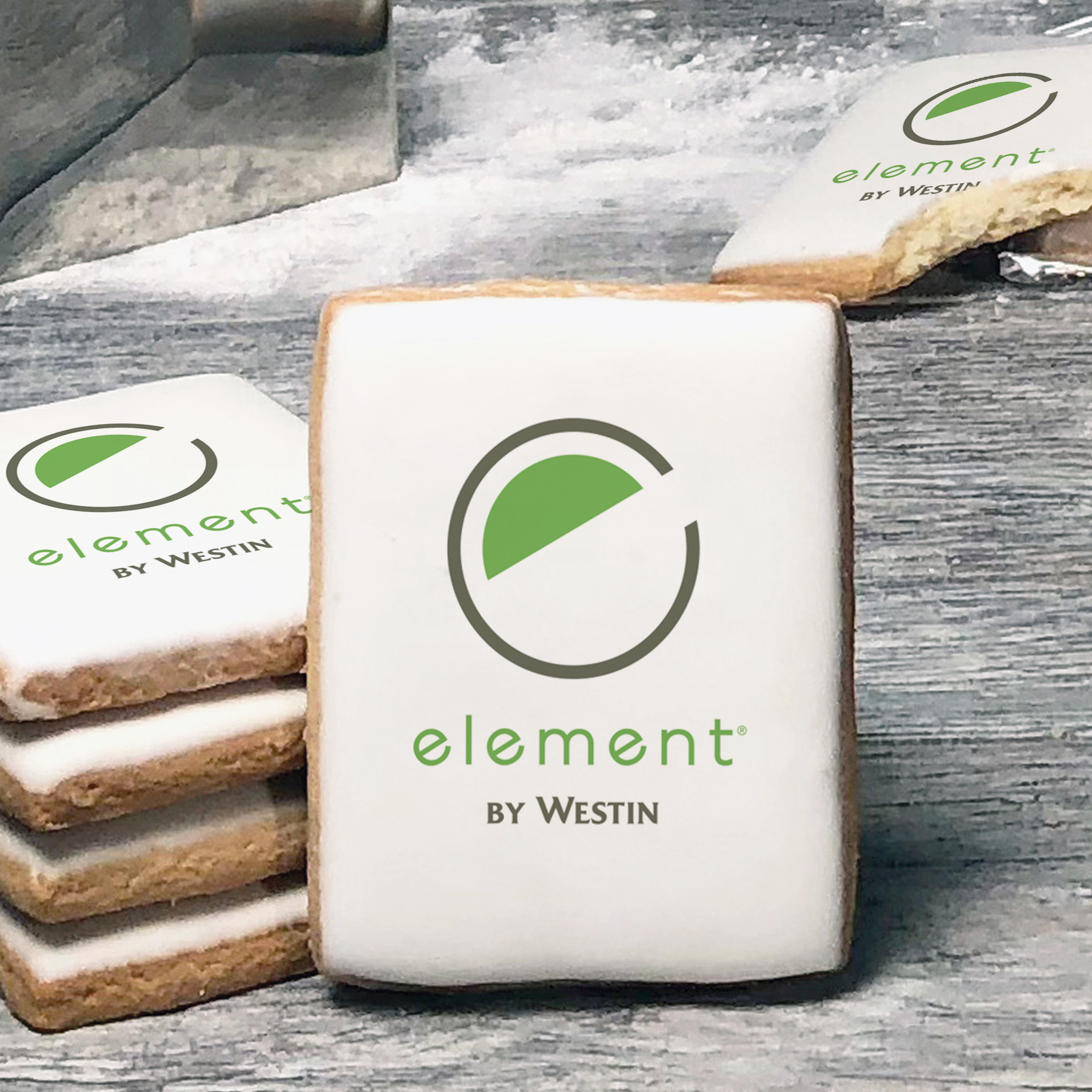 A stack of rectangle butter shortbread cookies with Element by Westin logo printed directly on a white, lemon sugar icing.