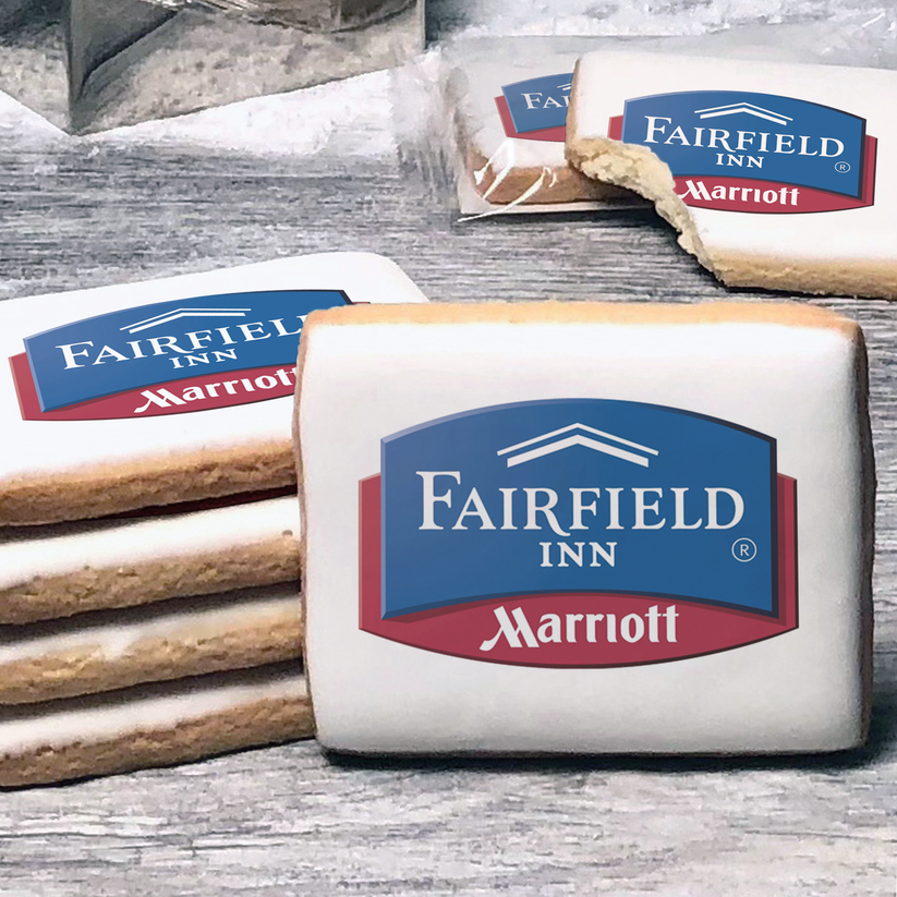 A stack of rectangle butter shortbread cookies with Fairfield Inn & Suites logo printed directly on a white, lemon sugar icing.