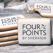 Load image into Gallery viewer, A stack of rectangle butter shortbread cookies with Four Points By Sheraton logo printed directly on a white, lemon sugar icing.