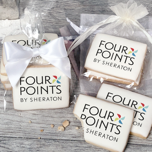 A stack of rectangular butter shortbread cookies with Four Points By Sheraton logo printed directly on a white, light sugar icing. Some cookies are shown in clear packaging with a twist-tie ribbon bow or inside an organza bag.