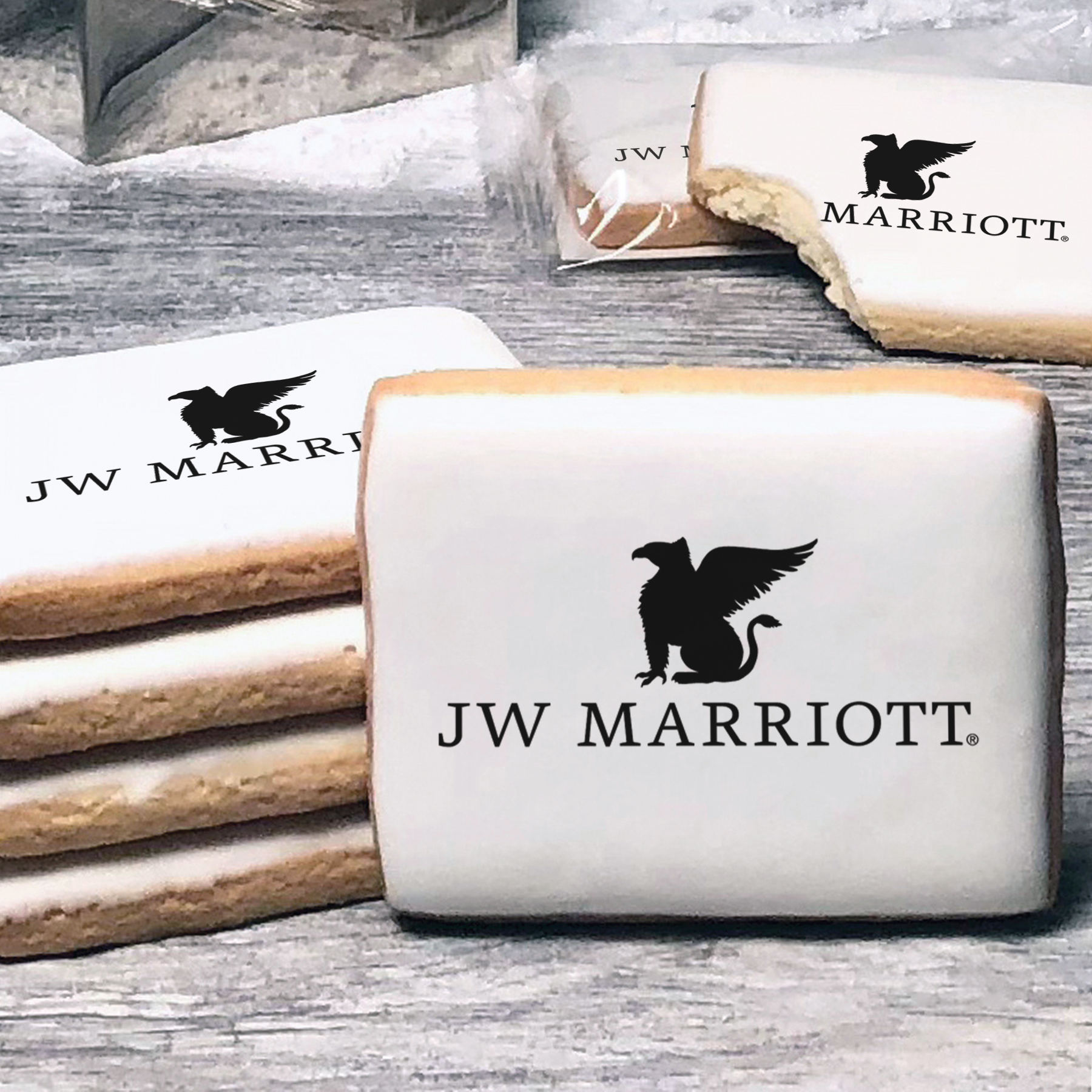 A stack of rectangle butter shortbread cookies with JW Marriott logo printed directly on a white, lemon sugar icing.