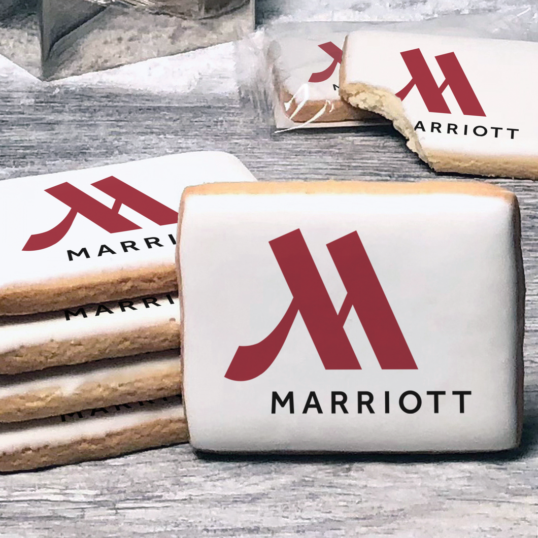 A stack of rectangle butter shortbread cookies with Marriott logo printed directly on a white, lemon sugar icing.