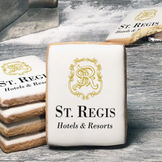 A stack of rectangle butter shortbread cookies with St Regis Hotels & Resorts logo printed directly on a white, lemon sugar icing.